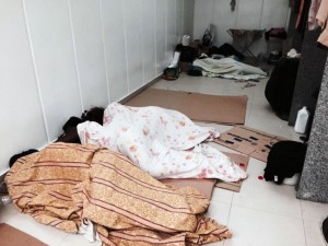Workers were caught sleeping on cardboard in the midst of cleaning materials and food remains